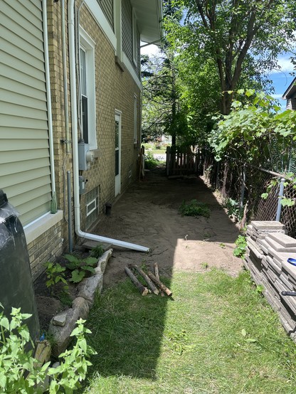 Side yard filled and regraded, grape trellis extended