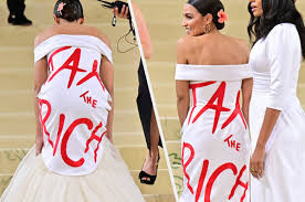 AOC in a white gala dress with the text on her back  